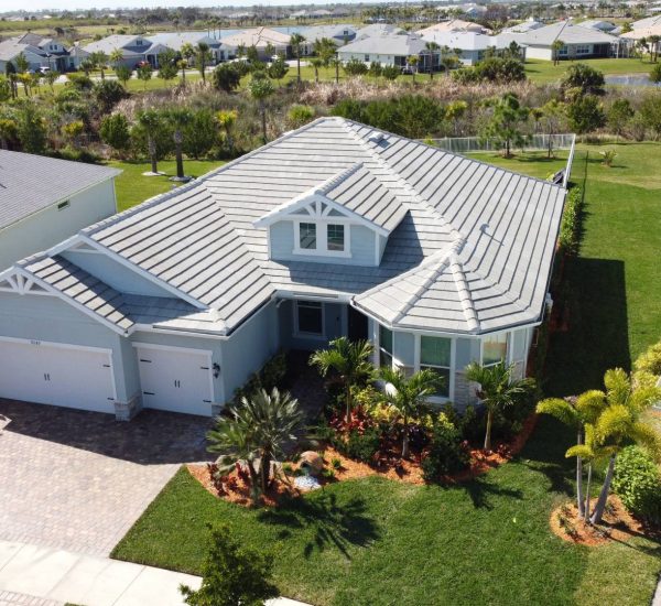 Modern single-story home in Hobe Sound, Florida after professional house washing by Clean Master, showcasing a spotless roof, driveway, and freshly cleaned exterior surfaces.